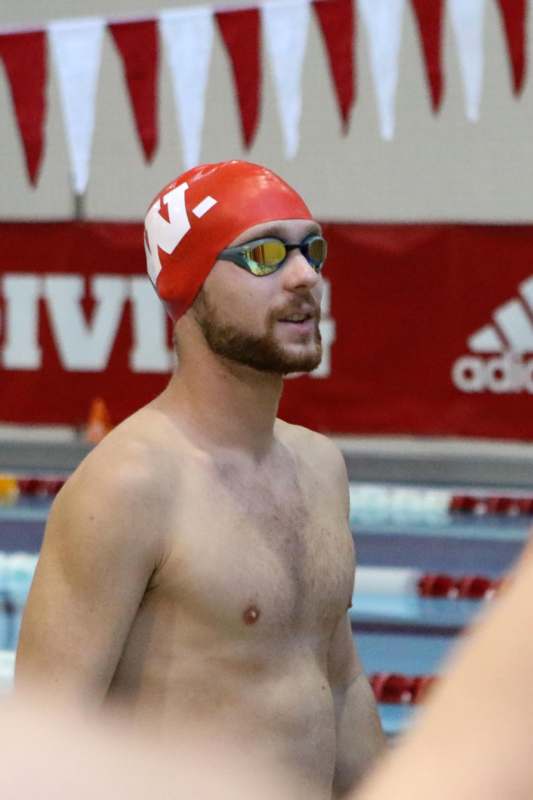 a man wearing a swim cap and goggles