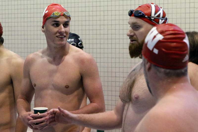 a group of men in swim caps