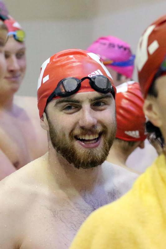 a man wearing a swim cap and goggles