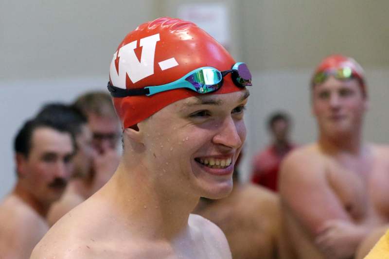 a man wearing a swim cap and goggles