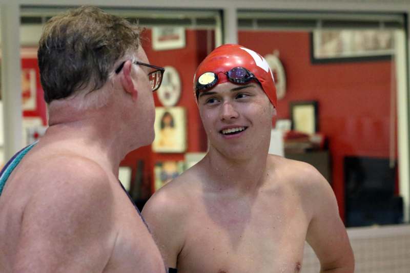 a man in a swim cap and goggles