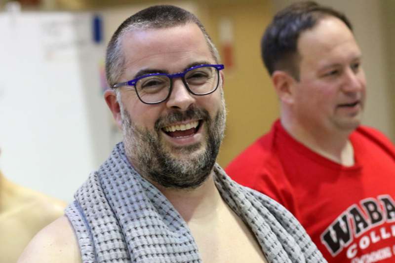 a man with a towel around his neck
