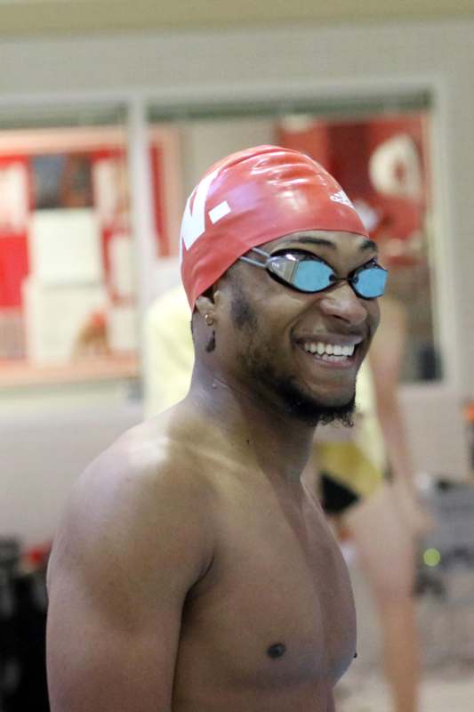 a man wearing a swim cap and goggles