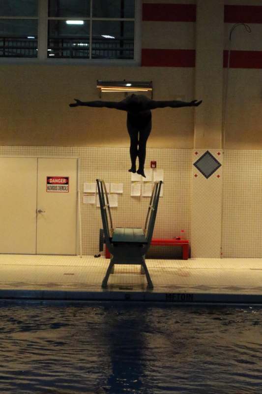 a person jumping into a pool