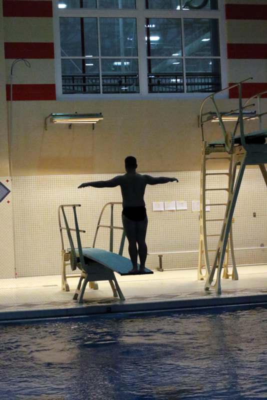 a man standing on a diving board