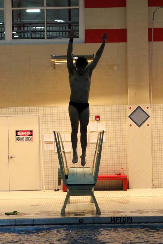 a man jumping off a diving board