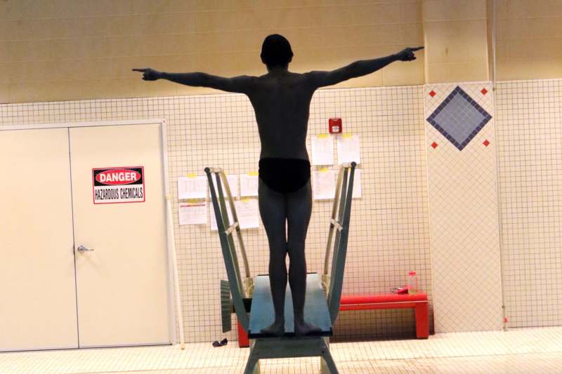 a man standing on a diving board