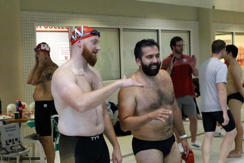 a group of men in swim trunks