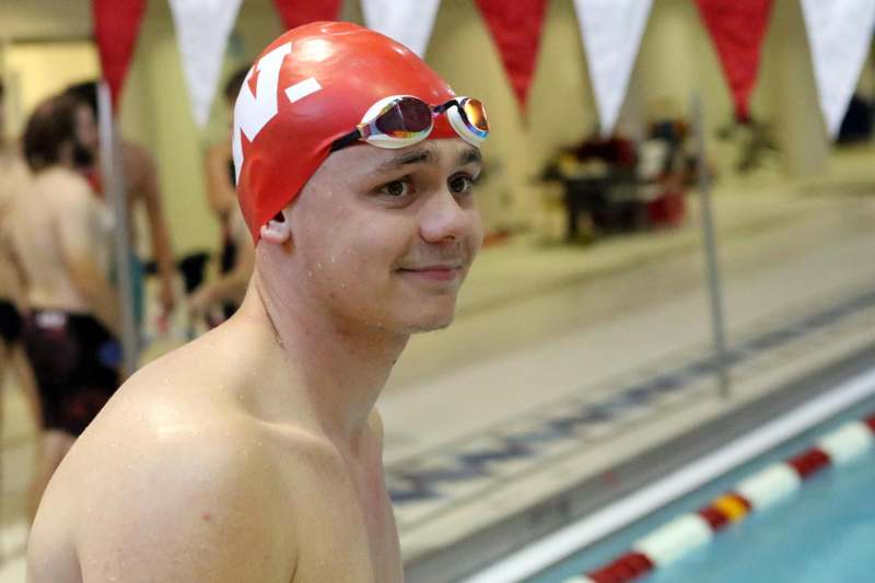 a man in a swim cap and goggles