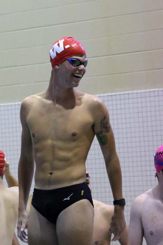 a man in swimsuit and goggles smiling