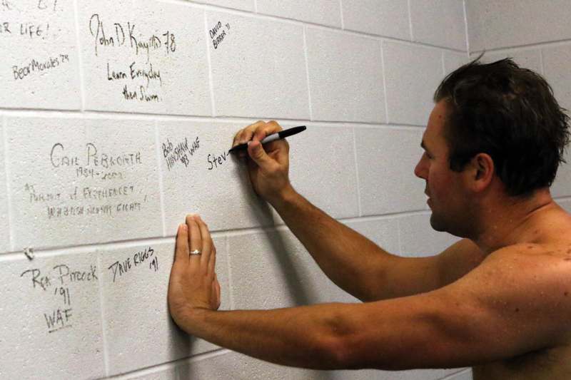 a man writing on a wall