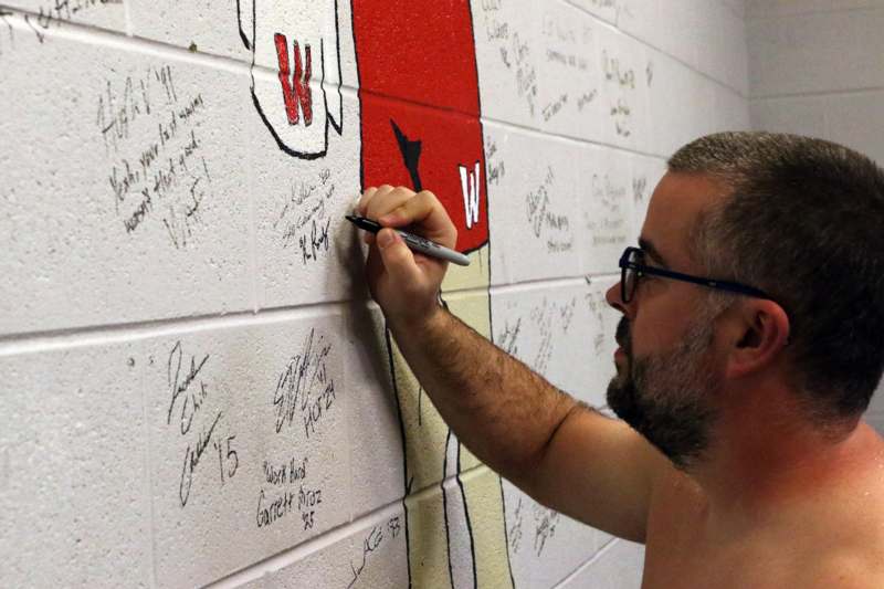 a man writing on a wall