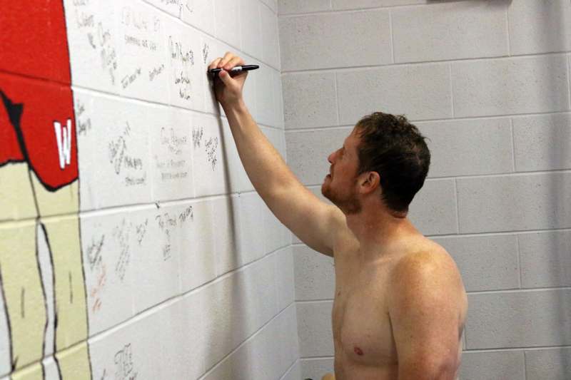 a man writing on a wall