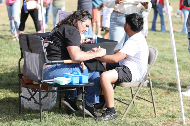 a man sitting in a chair holding a woman's hand