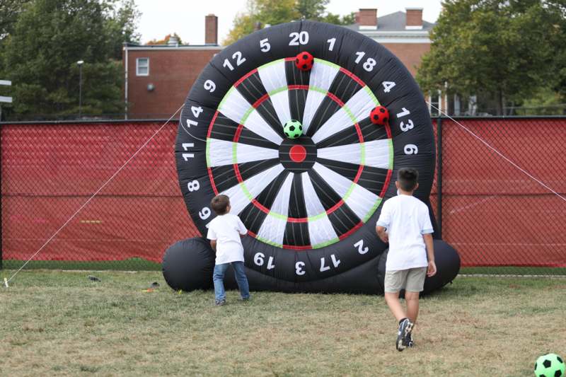 a group of kids playing darts
