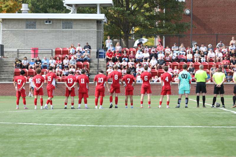 a group of people in red uniforms on a field