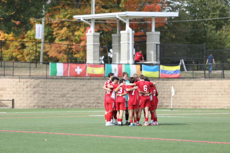 a group of people huddling on a field