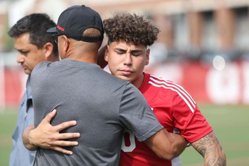 a man hugging another man