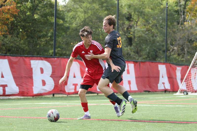 two men playing football on a field