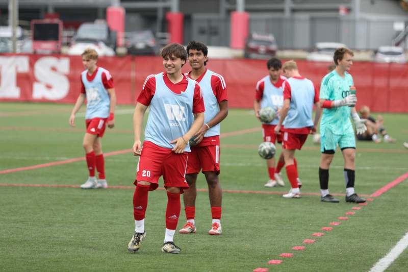 a group of men in sports uniforms on a field