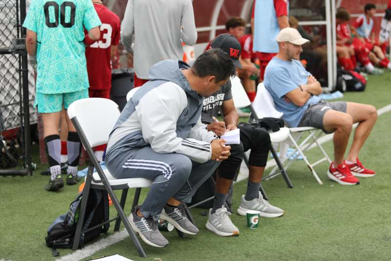 a group of men sitting on chairs
