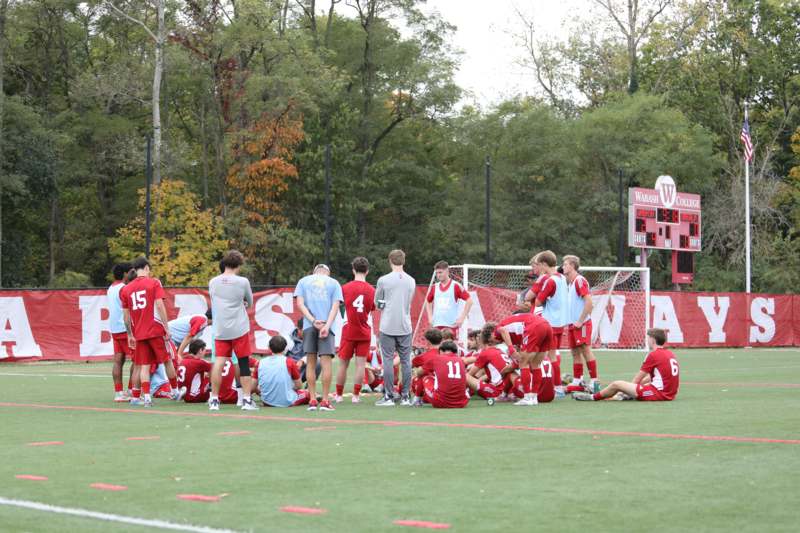a group of people in red uniforms on a field