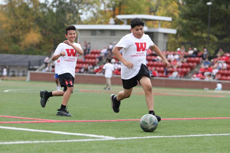 a pair of boys playing football