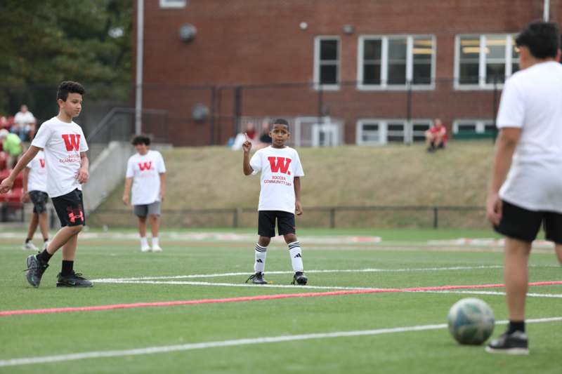 a boy on a field with a football ball