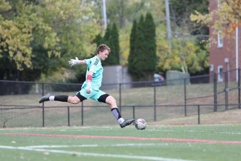 a man kicking a football ball