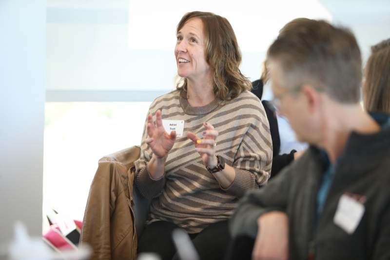 a woman sitting in a chair and talking
