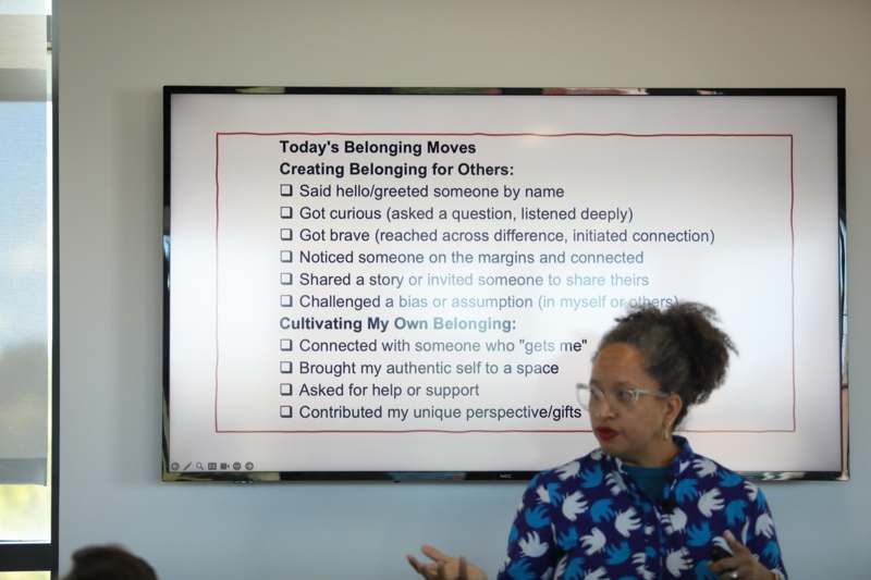 a woman standing in front of a whiteboard