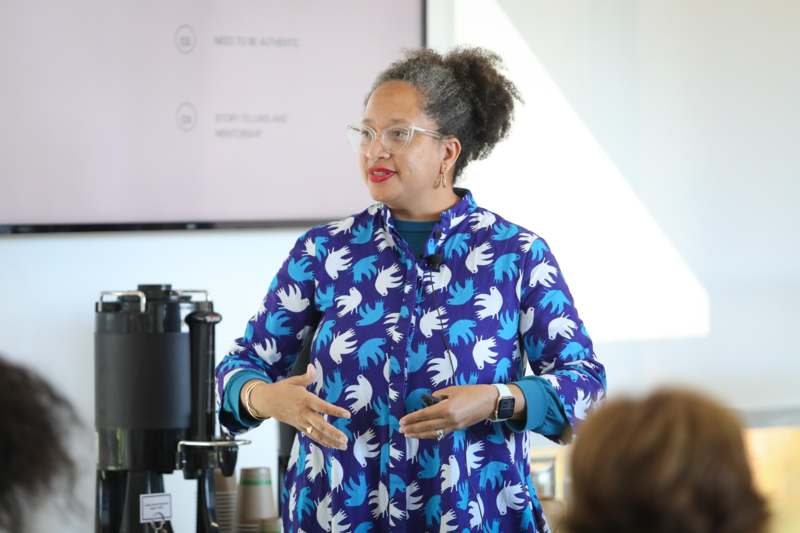 a woman in a blue shirt with white birds on it