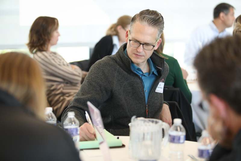 a man writing on a piece of paper