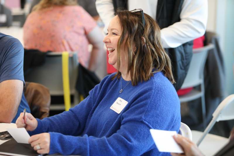 a woman laughing at a table