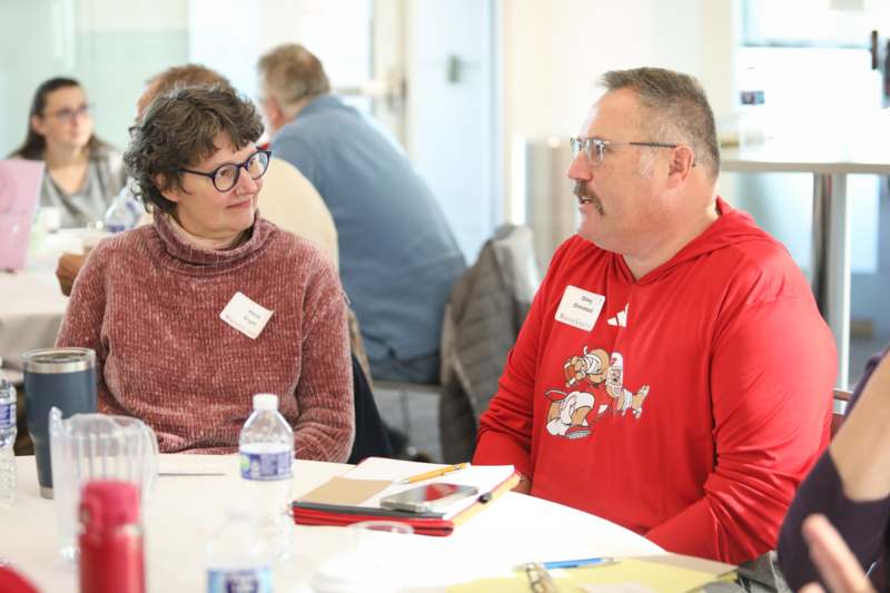 a man and woman sitting at a table