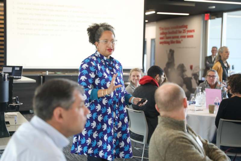a woman standing in front of a group of people