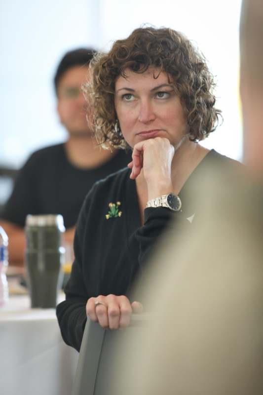 a woman with her hand on her chin