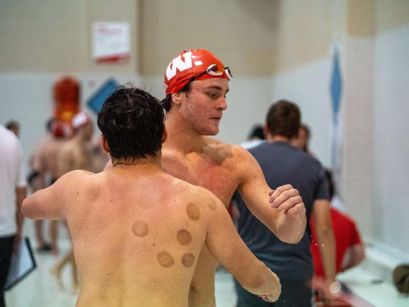 a group of men in a swimming pool