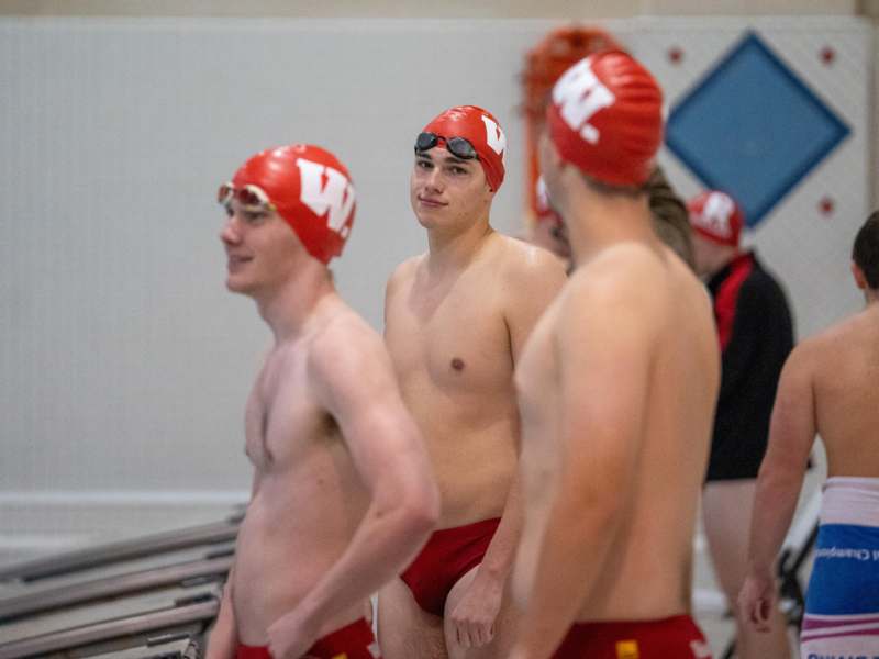 a group of men in swim caps