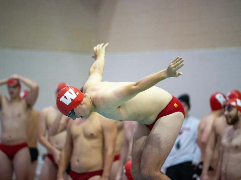 a man in red swimsuit and swimming cap