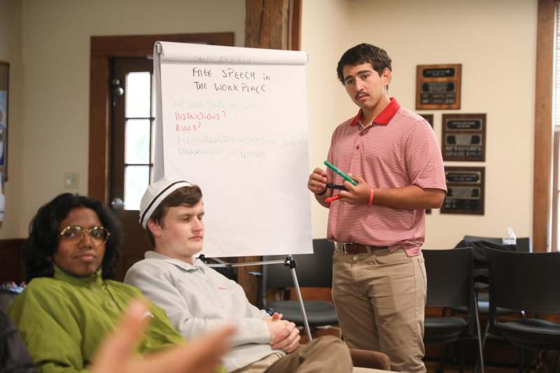 a man standing in front of a whiteboard