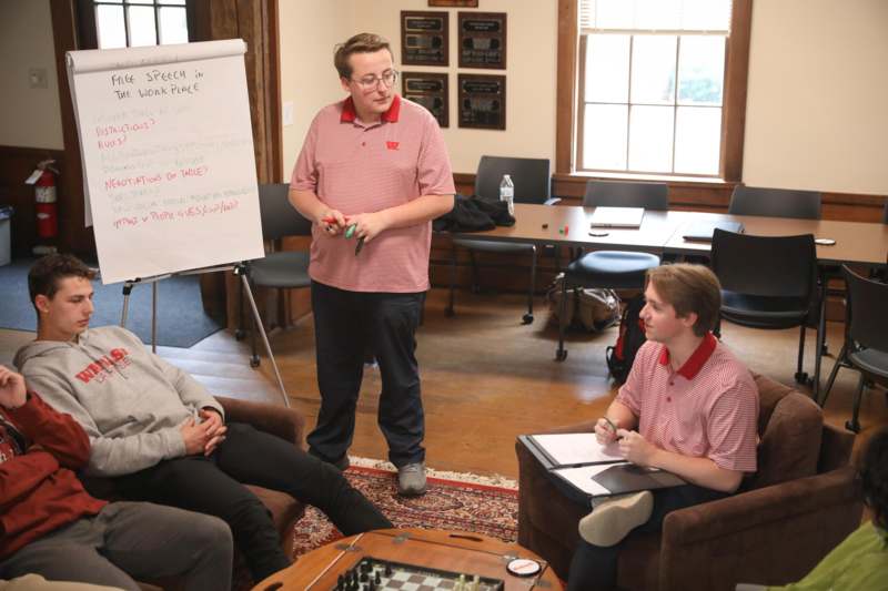 a man standing in front of a whiteboard