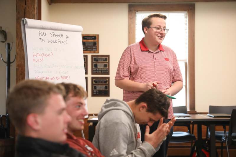 a man standing in front of a whiteboard