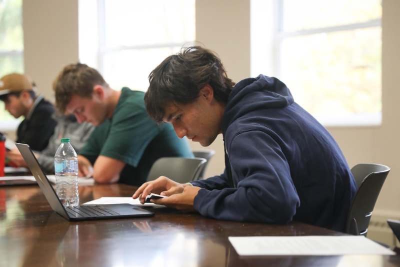 Classroom: SPA 401 with Professor Matthew Greenhalgh - a man sitting at a table with a laptop