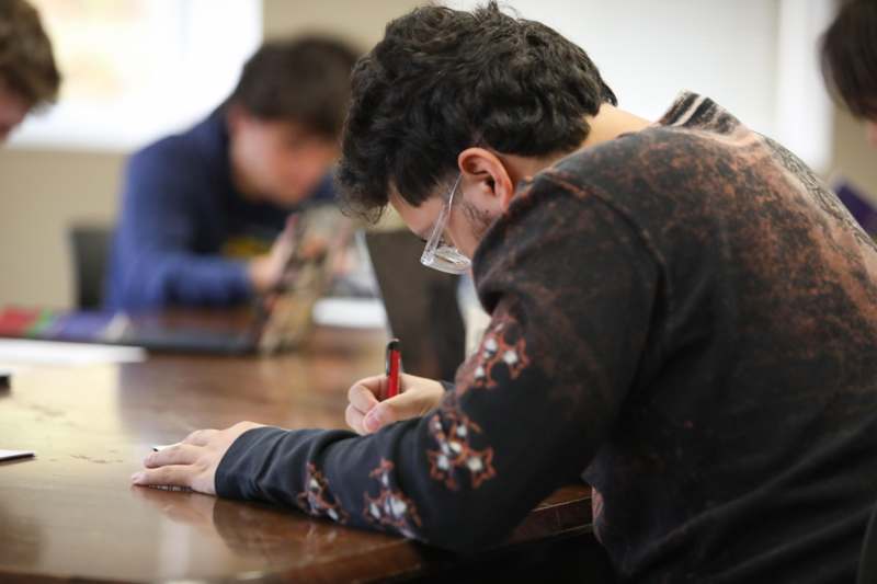 a man writing on a table