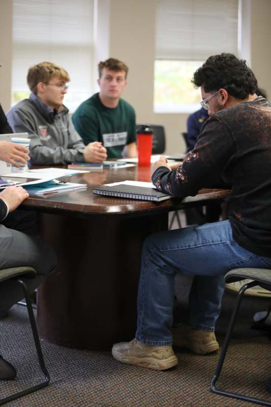 a group of people sitting around a table