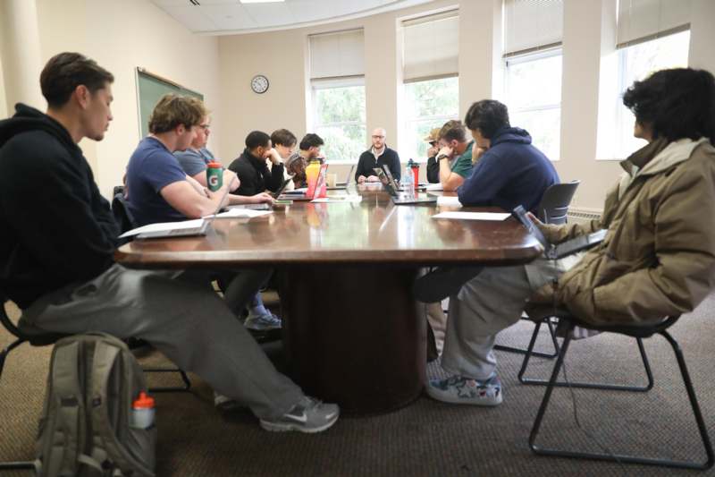 a group of people sitting around a table