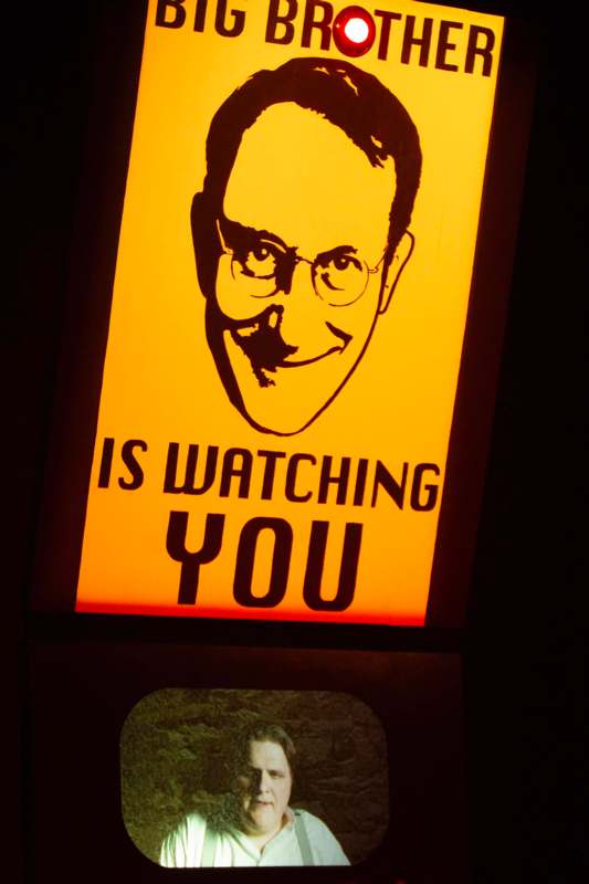 a yellow sign with a man's face on it