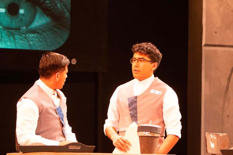 a man in vests standing next to another man