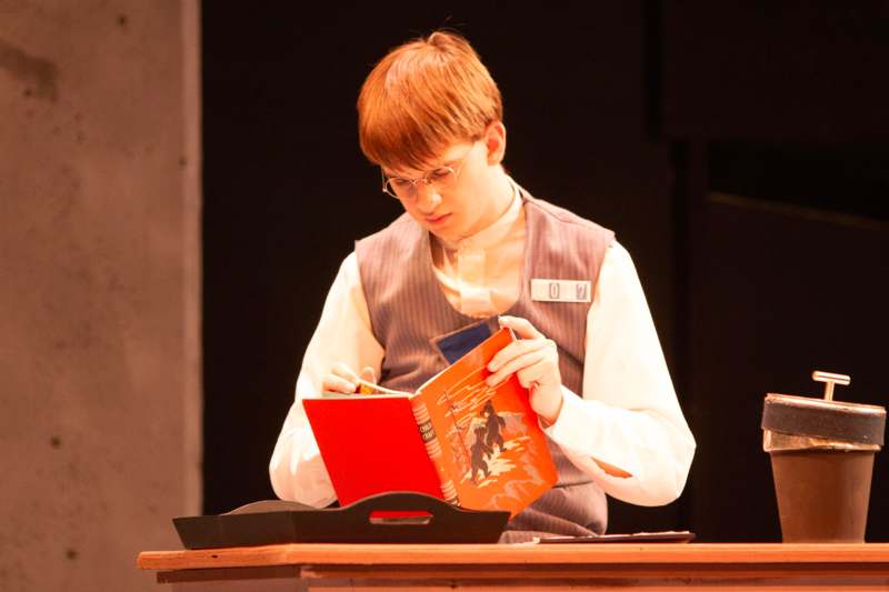 a boy writing in a book